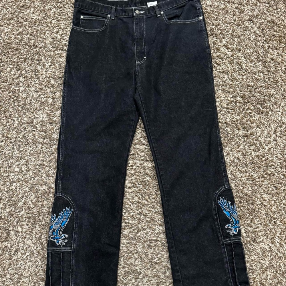 Baggy black denim jeans with blue bird design on leg
